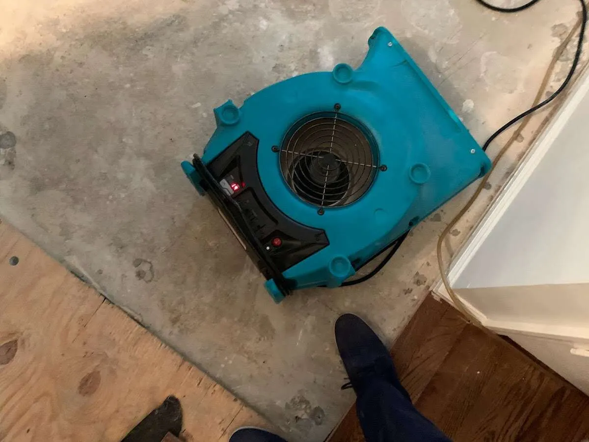 Air mover drying subfloor during Commercial Water Damage Restoration in Atlanta